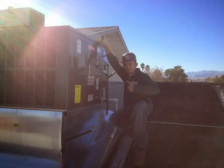 HVAC technician performing HVAC Inspection on a rooftop unit in Springfield